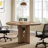 A round conference table with chairs in a well-lit office setting with large windows. Anteprima dell’immagine prodotto