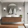 A modern bathroom with a double vanity, round mirror, and shower. Náhled obrázku produktu