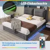 A dark gray upholstered bed with LED lighting and a remote control, shown in a bedroom setting. Náhled obrázku produktu