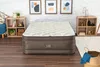 A mattress is displayed in a room with decorative items and furniture. Produktbild-Vorschau
