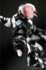A close-up of a black and white striped puppet with pink ears and blue eyes, sticking out its tongue. Produktbild-Vorschau