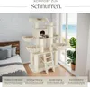 A cat tree is shown in a room with a bed and a window overlooking the ocean. Náhled obrázku produktu