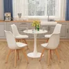 A white tulip-style dining table with four white chairs in a kitchen setting. Anteprima dell’immagine prodotto