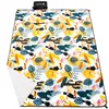 A picnic blanket with a tropical pattern is laid out flat. Náhled obrázku produktu