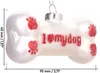 A white bone-shaped Christmas ornament with red paw prints and the text 'I ❤️ my dog' written on it. Dimensions are indicated by measurement lines. Náhled obrázku produktu