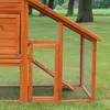 A close-up view of a wooden chicken coop with a wire mesh run. Produktbild-Vorschau