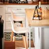A kitchen scene with bar stools and a kitchen island. Náhľad obrázku produktu