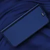 A blue flip case for a smartphone is shown on a dark blue, textured fabric background. Produktbild-Vorschau