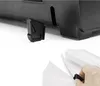 Close-up of a black accessory attached to a larger black product, and a hand holding a similar accessory to attach to white material. Anteprima dell’immagine prodotto