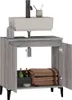 A bathroom vanity with a sink and faucet, showing the inside of the cabinet with towels and bottles. Produktbild-Vorschau