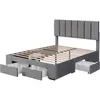 A gray upholstered bed frame with a slatted mattress support and four drawers underneath, shown against a white background. Produktbild-Vorschau
