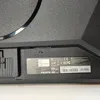 A close-up view of the back of a monitor, showing a label with product information and regulatory symbols. Náhľad obrázku produktu
