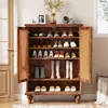 A wooden shoe cabinet with rattan doors, filled with various shoes and boots, placed in a room with a door and window. Anteprima dell’immagine prodotto