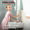 A young girl is washing her hands at a sink with a STIEBEL ELTRON water heater. Produktbild-Vorschau
