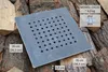 A square metal grate with circular holes is placed on a pile of chopped wood. Dimensions and model information are overlaid on the image. Anteprima dell’immagine prodotto