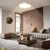 A modern living room with a sectional sofa, coffee table, and a decorative wall art. Voir les images du produit