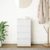 A white chest of drawers with books on top, a plant to the left, and a coat rack with a coat and bag to the right, all against a white wall. Anteprima dell’immagine prodotto