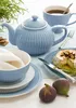 A table setting with a blue teapot, cup, bowl, plates, cheese, figs, and crackers. Produktbild-Vorschau