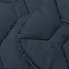 A close-up view of a dark blue quilted blanket. Produktbild-Vorschau
