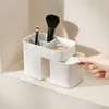 A hand is shown pulling a cotton pad from a drawer of a makeup organizer. Náhled obrázku produktu