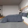 A bedroom scene with a bed, nightstand, and wardrobe. Voir les images du produit