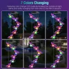 A collage of images showing a solar-powered wind chime with butterfly-shaped lights in a garden setting at night. Produktbild-Vorschau