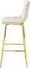 A side view of a beige velvet bar stool with gold legs against a white background. Voir les images du produit