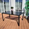 An outdoor table and chairs set on a wooden deck. Produktbild-Vorschau