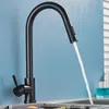 A black kitchen faucet with water running into a sink. Produktbild-Vorschau