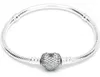 A silver bracelet with a heart-shaped charm covered in small stones, displayed on a white background. Anteprima dell’immagine prodotto