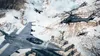 A chaotic battle scene in a snowy mountain environment with fighter jets, a helicopter, and soldiers on a pyramid-like structure. Produktbild-Vorschau