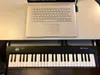 A laptop and a MIDI keyboard are placed on a desk. Produktbild-Vorschau