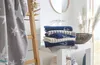 A bathroom scene with towels neatly folded on a shelf. Produktbild-Vorschau