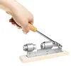 A hand is shown holding a nutcracker. Voir les images du produit