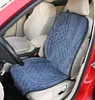 Interior of a car showing a blue seat cover on the driver's seat. Produktbild-Vorschau