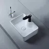 A white ceramic vessel sink with a black and silver faucet is shown on a gray countertop. Produktbild-Vorschau