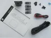 An overhead view of the contents of a JBL Bass Pro Nano subwoofer installation kit, including the manual, remote control, mounting hardware, cables, and a fuse. Voir les images du produit
