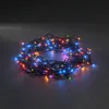 A coiled string of colorful LED lights on a dark surface. Produktbild-Vorschau