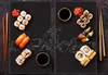 A collage of two images showing sushi and coffee cups drawn on a black surface. Produktbild-Vorschau