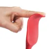A finger presses on a red silicone spatula, showing its flexibility. Produktbild-Vorschau