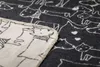 A close-up view of a blanket with a dog pattern. Produktbild-Vorschau