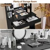 A split image showing a black vanity table with makeup and storage in the top panel, and a cluttered vanity top with makeup and a mirror in the bottom panel. Produktbild-Vorschau