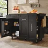 A kitchen island with open cabinets and drawers, stocked with various items like bottles, jars, and plates. The island is placed in a kitchen setting with a window and wall decor visible. Produktbild-Vorschau