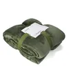 A folded olive-colored blanket is tied with a green ribbon and has a white tag attached. Produktbild-Vorschau