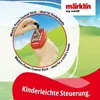 A hand holding a red toy train controller with a landscape background. Produktbild-Vorschau