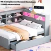 A grey daybed with storage drawers and a built-in shelf with LED lighting, featuring a tablet and a power strip with USB ports. Produktbild-Vorschau