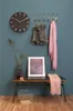 A hallway or entryway scene with a bench, clock, and coat rack. Náhled obrázku produktu