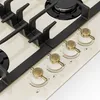 A close-up view of a cream-colored gas stovetop with black grates and gold control knobs. Náhľad obrázku produktu