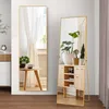 Two full-length mirrors are displayed in a room setting with plants and furniture. Náhled obrázku produktu