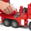 A child's hand is shown interacting with a red toy fire engine. Anteprima dell’immagine prodotto